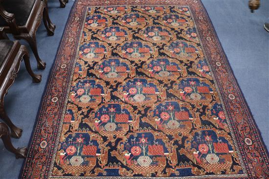 A Persian blue ground carpet, woven with stylised shrubs 260 x 170cm